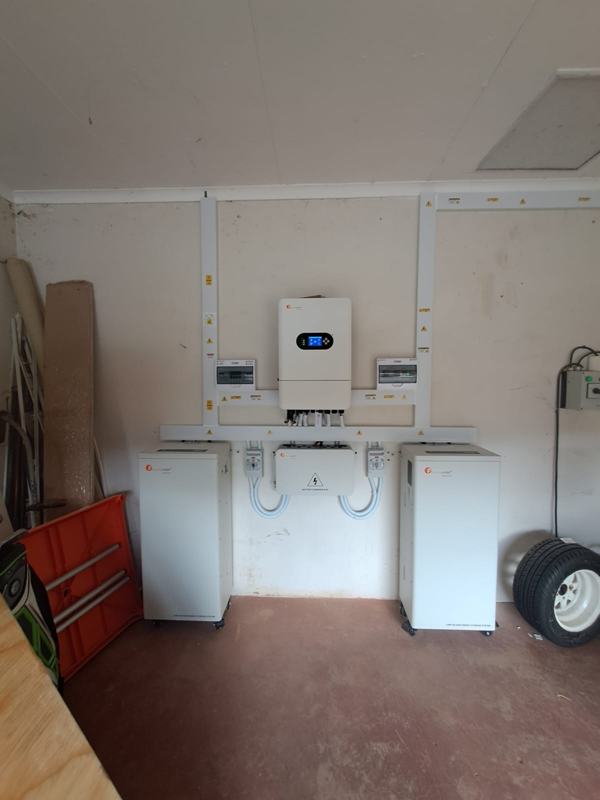 Felicity hybrid inverter with two battery cabinets joined through a battery combiner box.